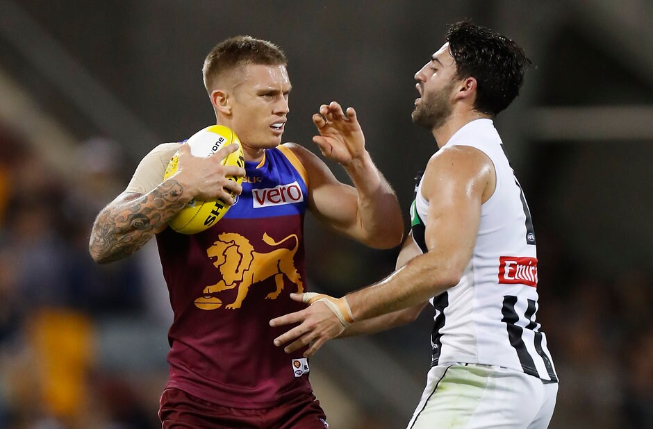AFL 2016 Rd 08 - Brisbane v Collingwood BRISBANE, AUSTRALIA - MAY 14: Dayne Beams of the Lions fends of Alex Fasolo of the Magpies during the 2016 AFL Round 08 match between the Brisbane Lions and the Collingwood Magpies at The Gabba, Brisbane on May 14, 2016. (Photo by Michael Willson/AFL Media)